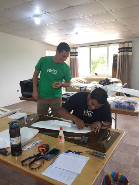 two men work on uav